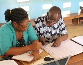 Project staff in Mtwara region, Tanzania, review monitoring data of insecticide-treated nets (ITNs).