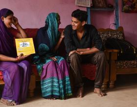 Source - © 2016 Arvind Jodha/UNFPA, Courtesy of Photoshare. Description - An Accredited Social Health Activist (ASHA) in India explains the various family planning methods to a couple, as the young bride shies away. 