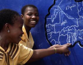 Woman pointing to an African country on a map