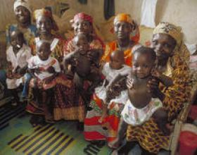 Group of mothers waiting with their children in the waiting room of a public health facility in Nigeria.