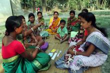 A rural health worker teaches women about the IUD and other contraceptive methods in remote Kushamandi, South Dinajpur, West Ben