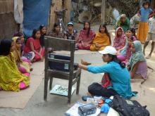 Description-Info Lady shows video to adolescent girls. Source-© 2012 Cassandra Mickish/CCP, Courtesy of Photoshare.