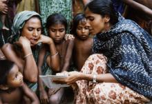 Source - © 1994 Cheryl Groff, Courtesy of Photoshare. A Family Welfare Assistant shares family planning information with villagers in the Trishad District of Bangladesh. A Family Welfare Assistant shares family planning information with villagers in the Trishad District of Bangladesh.