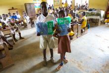 Addo and Festus, students at Amanhyia Catholic School in Ghana, receive long-lasting insecticide-treated bed nets (LLINs)