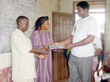 Man handing a box to a couple