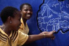 Woman pointing to an African country on a map